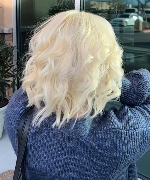 A woman with blonde hair is taking a selfie