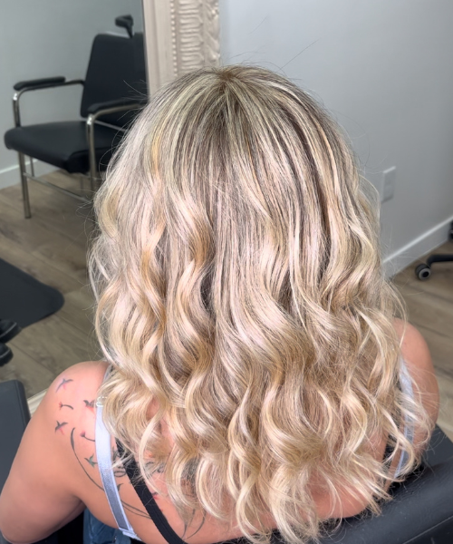 The back of a woman's head in a hair salon