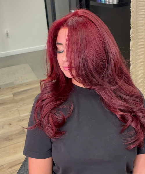 A woman with long red hair sitting down