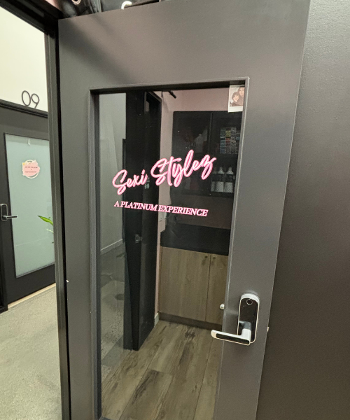 A door with a pink sign on the side of it